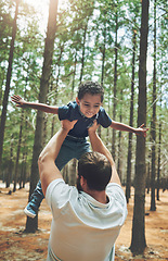 Image showing Forest, adoption and love of father lifting son to play airplane wings or flying in air game. Foster, interracial and family with happy black kid bonding with caucasian dad in Canada nature.