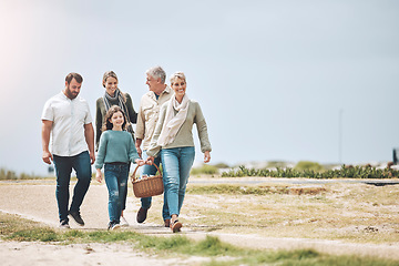 Image showing Big family, happy and walking for a picnic on holiday, vacation or weekend trip outdoors for relaxing and bonding. Mother, father and grandma travel with old man and girl child to enjoy quality time