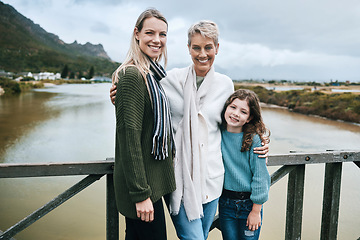 Image showing Portrait of grandmother, mother and girl on bridge happy and enjoying family vacation, Travel, journey and adventure with parents, kid and grandparents standing by lake on holiday, travelling and joy