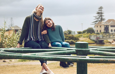 Image showing Mother, child and hug, playground and at park having fun on merry go round, together bonding outdoor in nature. Woman, girl and laughing, childhood and family, spending quality time in countryside.