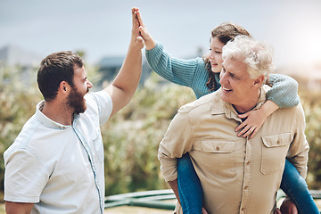 Image showing High five, grandfather and father with girl child walking in nature with piggyback ride. Happy, smile and family on outdoor walk together while on a summer vacation, adventure or holiday in Australia