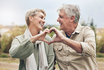 Image showing Love, heart sign and senior couple with marriage happiness, healthy and wellness lifestyle in countryside. Elderly people man, and woman with loving hands in park or nature retirement holiday