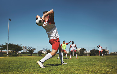 Image showing Football throw and field game of a team in a fitness, exercise and sports match outdoor. Training, soccer workout and athlete teamwork collaboration ready for cardio together in the summer sun