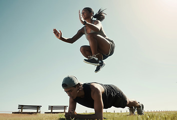 Image showing Man, black woman and fitness in park, nature garden or sustainability environment for workout, training or exercise. Jumping, plank and sports people, friends or couple with energy and wellness goals