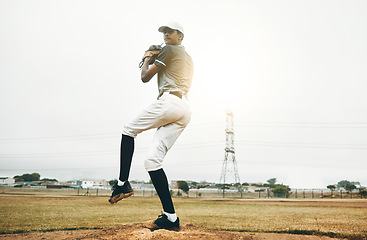 Image showing Baseball player, pitch and sports athlete man outdoor on a field with focus and fitness. Game training, exercise and team workout of a strong person playing baseball ready for cardio and exercising