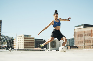 Image showing Soccer player, woman and soccer ball kick in fitness, training or exercise on Portugal city building rooftop. Football player, sports person and athlete in energy workout for health or wellness goals