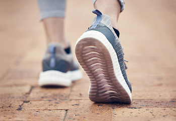 Image showing Runner, shoes and outdoor walk of a woman feet before fitness, workout and running exercise. Sport training, foot walking and healthy cardio of a person on a brick pavement ready for a sports run