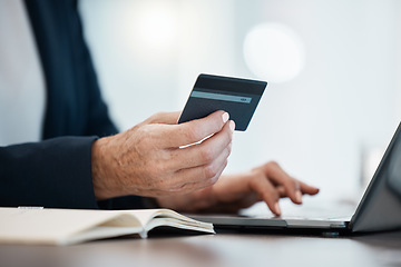 Image showing Hand, laptop and credit card with an accountant online making a payment from a desk in the office. Computer, accounting and finance with a business person shopping or making an ecommerce purchase