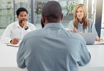 Image showing Interview, recruitment or hiring with hr team in meeting with job seeker, professional or unemployed man in company office. Business people listen to question, negotiation or answer of person for job