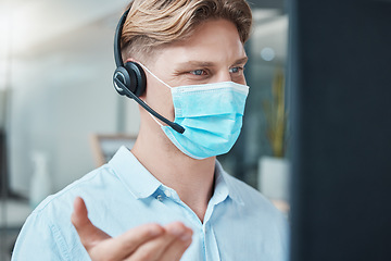 Image showing Call center, face mask and telemarketing agent talking on headset for customer service and support inside crm office. Contact us advisor or sales man consulting online using pc during covid outbreak