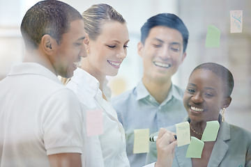 Image showing Teamwork, sticky note and collaboration while writing idea and employees planning strategy for innovation, vision and goals in office meeting. Diversity team working on schedule for marketing project