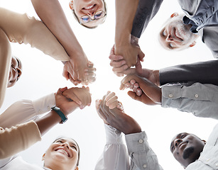 Image showing Hands, teamwork and motivation with a business team in a huddle or circle together from below. Collaboration, success and community with a man and woman employee group standing hand in hand in unity