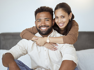 Image showing Couple, smile and sofa for portrait with back, woman or love in living room while home together. Black woman, man and happy for embrace, care or hug on couch with happiness, face or bonding in lounge