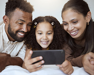 Image showing Black family, phone and child on bed for video, smile or happy for streaming, cartoon or movie. Mom, dad and kid with smartphone in bedroom to game, internet or watching to relax, happiness or play