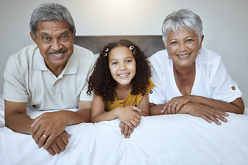 Image showing Happy, grandparents and child lying on bed with smile for family bonding, retirement and relax at home. Portrait of little girl, grandma and grandpa smiling in bedroom relaxing together for childcare