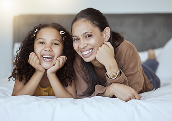 Image showing Happy, relax and portrait of mother and girl with smile on the bed in bedroom together in family home. Happiness, love and woman from Mexico laying with her child to rest, relax and bond at the house