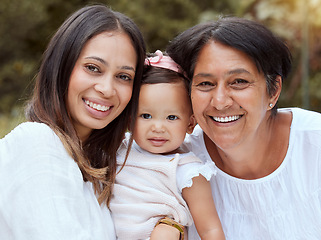 Image showing Mother, baby and family bonding outdoor with a smile, love and care in a nature park. Portrait of women generations, mama and elderly woman holding a young girl feeling happy with quality time