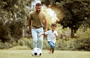 Image showing Father, child and playing with soccer ball in the park for fun quality bonding time together in nature. Dad and kid enjoying family weekend, break or exercise for playful summer of soccer outside