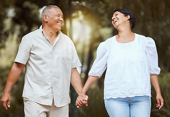 Image showing Happy, support and love senior couple enjoy a romantic walk at the forest together on a sunny day. Smile affectionate husband and wife holding hands bonding on vacation and retirement outdoor