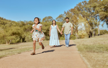 Image showing Family, park and together, nature and outdoor, parents holding hands and girl running, spending quality time outside. Mexican man, woman and child, fun in the sun and bonding, happy and summer.