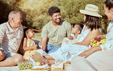 Image showing Black family, picnic with food in a nature park in summer happy about quality time together. Happiness of parents, children and elderly people with a smile, love and care outdoor in the sun with kids