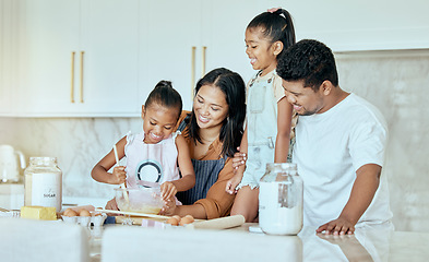 Image showing Happy, mother and father baking with children for family bonding, learning and teaching in the kitchen at home. Mama, dad and little girls helping parents with smile for mixing ingredients together