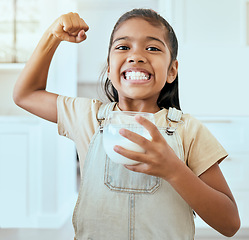 Image showing Happy, health and milk by girl strong bone pose in living room, drinking milk for wellness, teeth and child development. Portrait, face and happy, proud and empowered child happy with breakfast drink