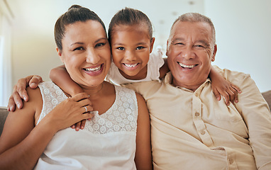 Image showing Family, portrait and grandmother with grandfather hug in home with excited and happy grandchild. Affection, happiness and grandparents enjoying leisure in Indonesia family home with little girl.