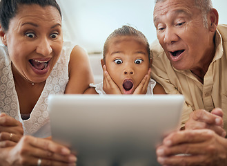 Image showing Tablet, family and shocked face child look at video online bonding together at home. Wow grandparents, young girl and fun activity streaming movie or excited news on digital device in living room