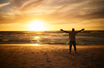 Image showing Freedom, beach and man silhouette celebration at sunset, happy and success in nature. Motivation, health, and energy challenge winner by a guy shadow cheering and express victory, happiness and joy