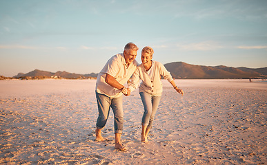 Image showing Retirement, senior couple and love being on beach, sand and walking being happy, smile and relax together. Romantic, mature man and elderly woman on seaside vacation, holiday and bonding for romance.