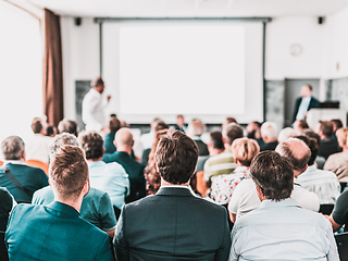 Image showing I have a question. Group of business people sitting in conference hall. Businessman raising his arm. Conference and Presentation. Business and Entrepreneurship