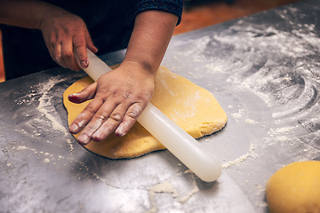 Image showing Woman hand pressing out cookie dough