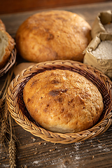 Image showing Whole fresh bread in wicker basket