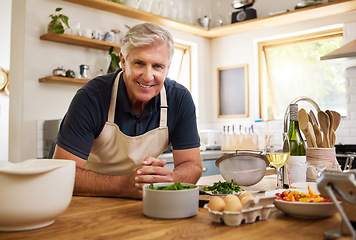 Image showing Senior, man and smile for cooking in portrait in kitchen while happy, proud or home. Elderly, chef or food in retirement for recipe, vegetables or ingredients on table, counter or house for happiness