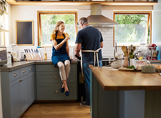 Image showing Couple, wine and cooking in kitchen, happy and talking while bonding, conversation and home. Senior, man and woman in retirement with glass, food and together in house with love, romance and laugh