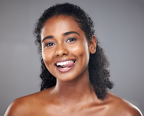 Image showing Happy black woman, face portrait and tongue out for healthy skincare morning routine. Beautiful young african girl, smile and fun cosmetic beauty wellness lifestyle or natural care in studio