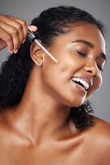 Image showing Black woman, face moisturizer and oil serum, beauty and skincare, natural cosmetics ad in studio background. Happy model, apply makeup product and glow, healthy skin and fresh, facial treatment.