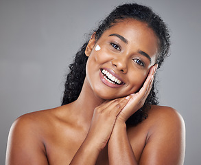 Image showing Woman, skincare cream and face portrait, sunscreen makeup product and luxury beauty cosmetics for wellness on studio background. Happy indian model, facial spf lotion or natural aesthetic dermatology