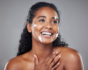 Image showing Skincare, beauty and face cream by black woman in studio mockup for wellness, hygiene and grooming. Black woman, facial and skin health by model smile, relax and enjoy treatment on grey background