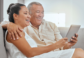 Image showing Tablet, movie and senior couple streaming a film on the internet from the living room sofa of their house. Happy elderly man and woman on a subscription service website for a film with tech on couch
