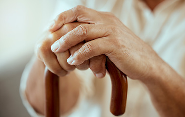 Image showing Senior man hands, walking stick and disability, retirement and osteoporosis, arthritis and injury. Wooden cane of elderly, disabled and old patient support, healthcare and sick help in nursing home