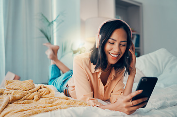 Image showing Woman, phone and headphone relax, streaming music online or audio. Radio, podcast and content for entertainment on the internet or happy free time listening on earphones in home bedroom in peace