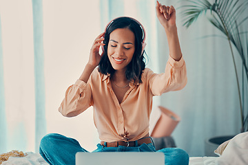 Image showing Woman, music and bed with laptop, dancing and headphones in bedroom, relax and smile. Girl, dance and room with streaming, computer and listen on web, internet and app for radio, audio and technology