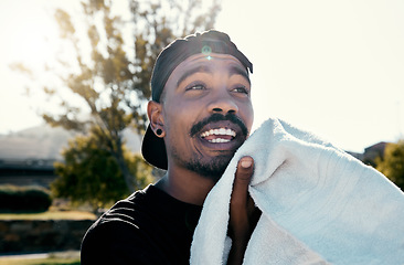 Image showing Black man, face and towel while outdoor for fitness, health and exercise in park, street or town. Man, young and gen z in summer, sunshine or trees with cloth for dry, sweat or skin in Los Angeles