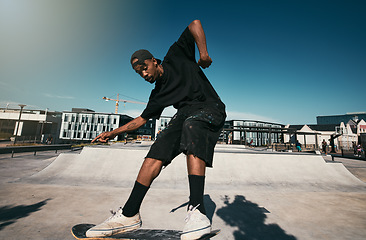 Image showing Black man, skater on skateboard and skate trick in a park in Los Angeles California summer sun for fitness, exercise and fun. Extreme sports athlete, cardio workout and skating competition training