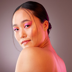 Image showing Face, eyeshadow and neon makeup of woman on gray studio background. Portrait, unique skincare or facial beauty cosmetics treatment of a beautiful female, girl or model from Japan with glowing skin.