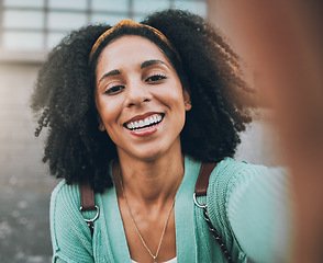 Image showing Selfie, travel and happy with a black woman tourist in the city for sightseeing or exploring outdoor. Street, face and portrait with a young female traveler taking a photograph in an urban town