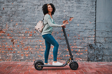 Image showing Black woman, electric and scooter in city with smile, happy and relax for summer day, edgy and trendy on sidewalk. Yong female, girl and eco friendly transportation have fun, cheerful and in street.