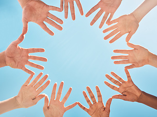 Image showing Open hands, circle and diversity support, people and community group and freedom of racism on blue sky background. Below solidarity, partnership and motivation of goals, trust or global collaboration